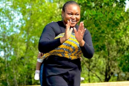 Ruth Kadiri Carrying Second Daughter On Her Back